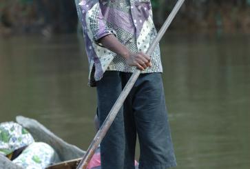 A man canoeing in Orientale, Democratic Republic of the Congo. 