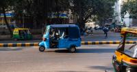 Electric auto-rickshaw on street in in New Delhi.