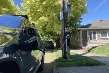 Electric vehicle charging at pole-mounted charging station