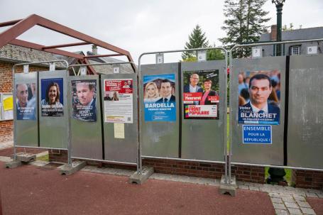 French campaign posters hang on a makeshift wall.