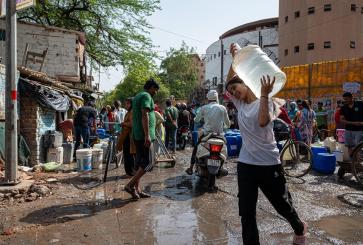 A woman carries water during a blistering hot day in New Delhi, India.
