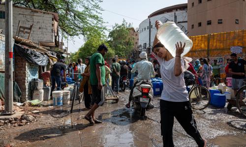 A woman carries water during a blistering hot day in New Delhi, India.