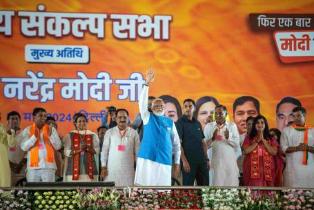 Narendra Modi, India's Prime Minister, waves to party supporters during a campaign rally.
