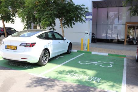 Electric car parking spots are painted green withHebrew writing in Israel.