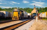 Several trains carrying freight gather on tracks