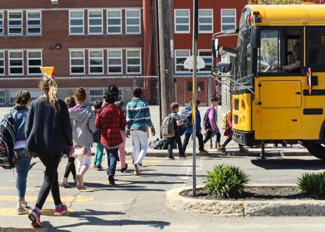 Children board school bus