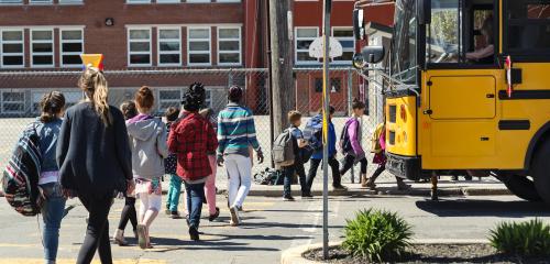 Children board school bus