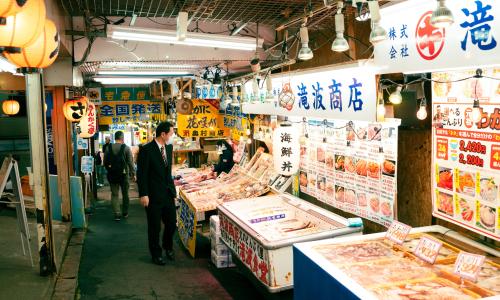 A customer looks over the seafood at a Japanese seafood market.