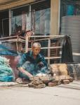 In Nepal a man cooks food outside