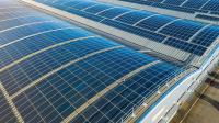 Large solar panels on roofs of industrial units and warehouses