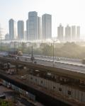 Highway with city skyline in background.