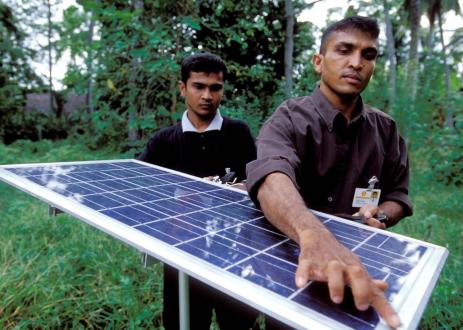 Men carrying solar panel