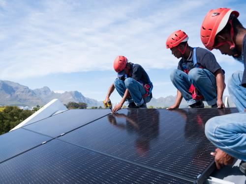 men working on solar panels