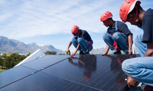 men working on solar panels
