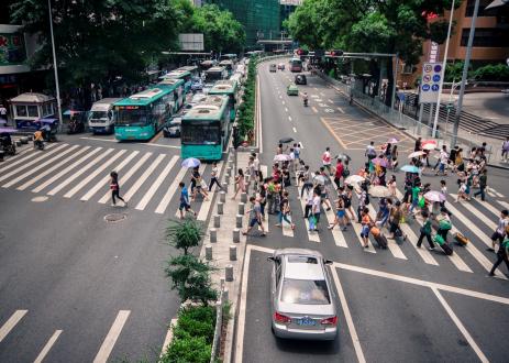 People on crosswalk across large street