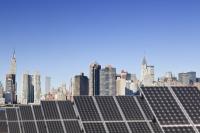 Roof top solar installation with Midtown Manhattan view as background.