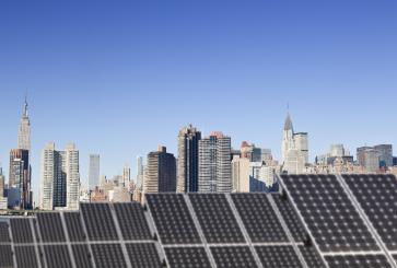 Roof top solar installation with Midtown Manhattan view as background.