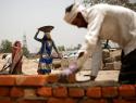 Brick layers during in a heatwave in New Delhi, India