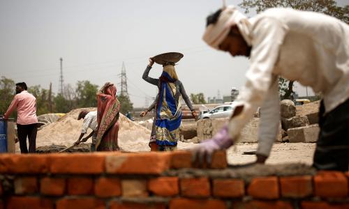 Brick layers during in a heatwave in New Delhi, India