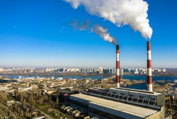 A smokestack of a garbage incineration plant against the backdrop of the city