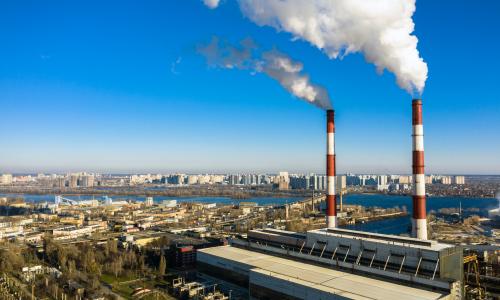A smokestack of a garbage incineration plant against the backdrop of the city
