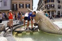 A line of tourists await the use of the fountain at the base of Rome’s Spanish Steps to cool off.