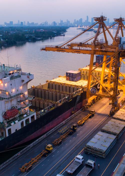 Shipping scene on a river looking over a large city.