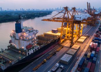 Shipping scene on a river looking over a large city.