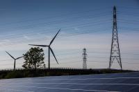 Solar panels, wind turbines and electricity pylons.