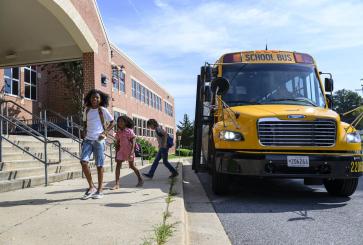 Children getting off school bus.