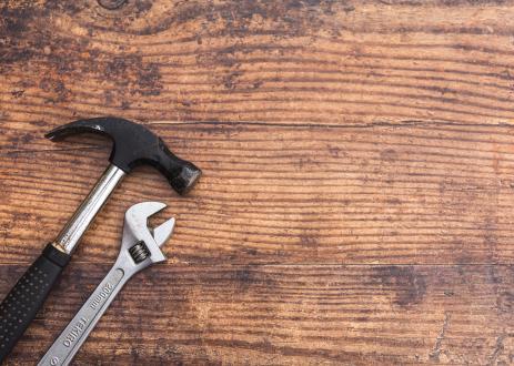 Hammer and wrench on wood