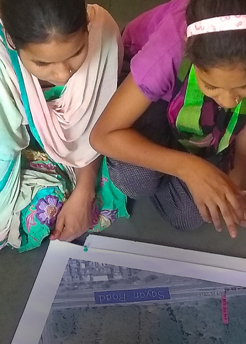 women sitting in a circle looking at a map